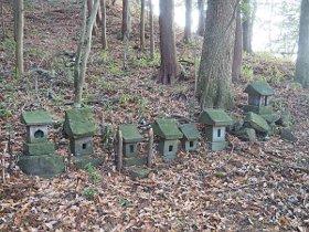 複数の石の置物が山道に並んでいる写真